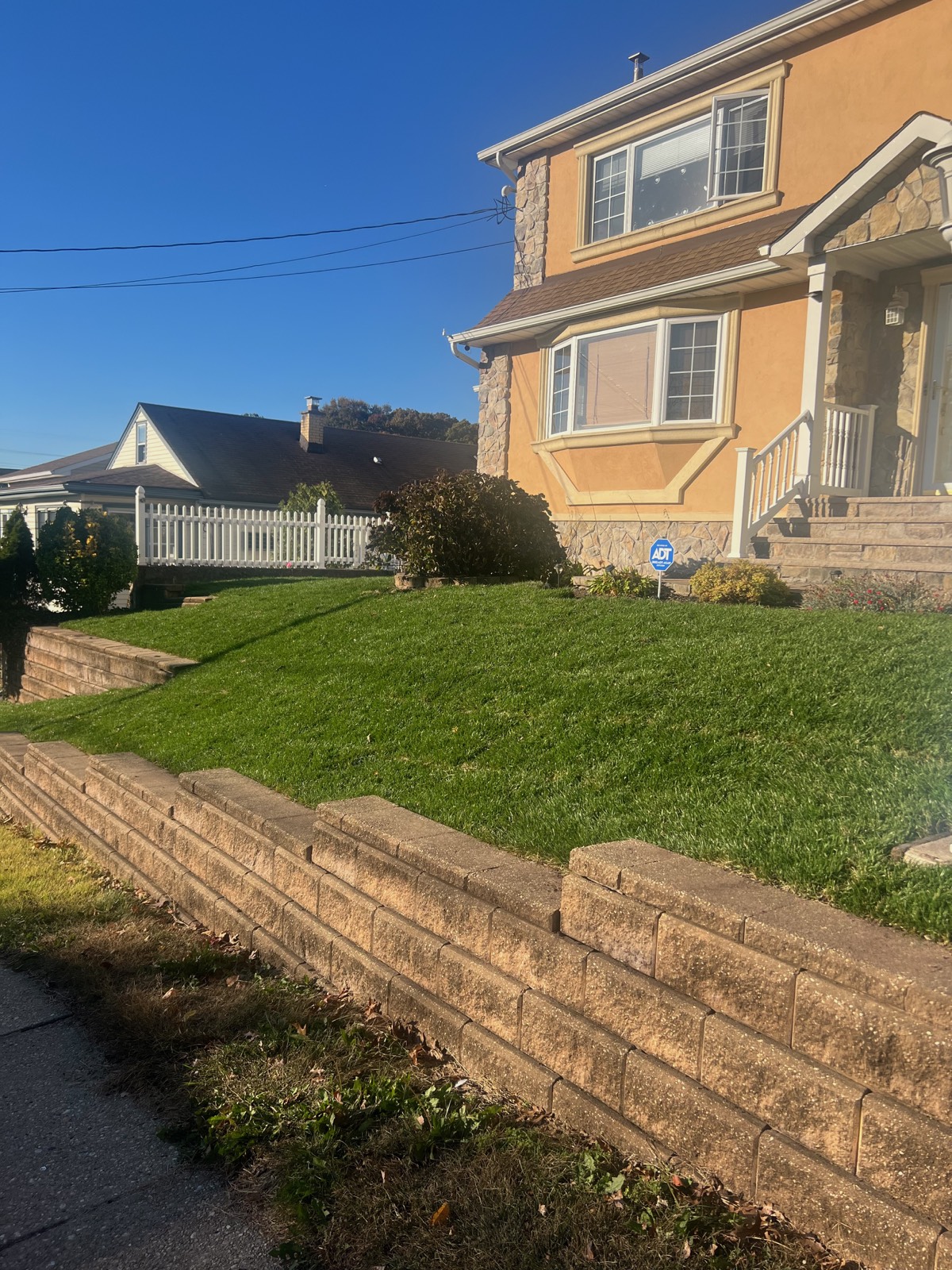 Maintenance team refreshing mulch and trimming shrubs